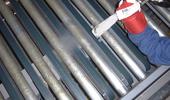 Cleaning conveyor systems in latex factory